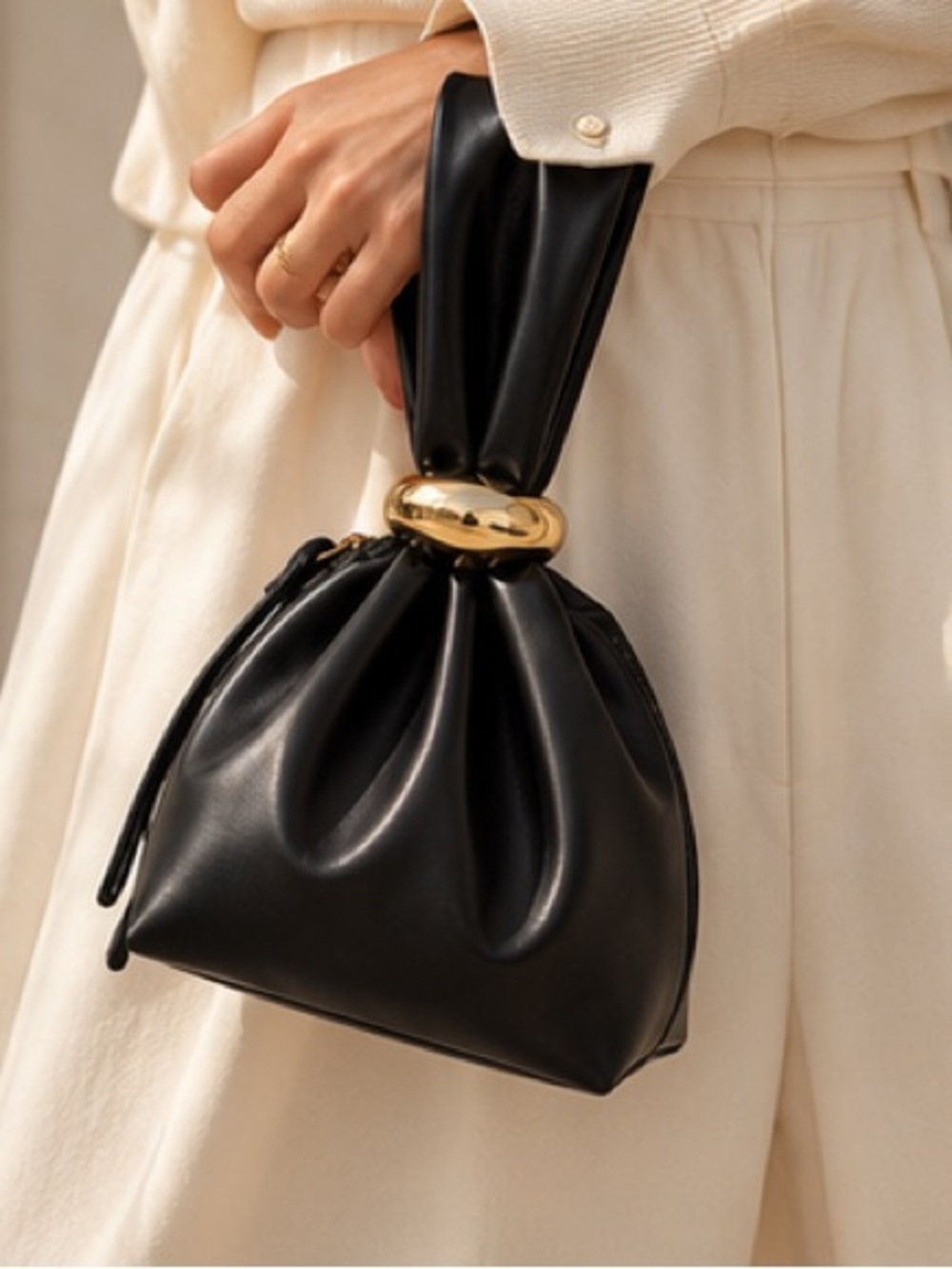 Sculptural Noir Leather Mini Bag with Polished Gold Signature Clasp